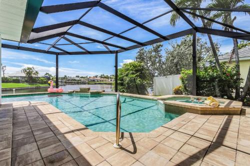 Pelican House | Riverfront Luxury with Heated Pool, Spa & Private Dock - Sunny Shores Escape