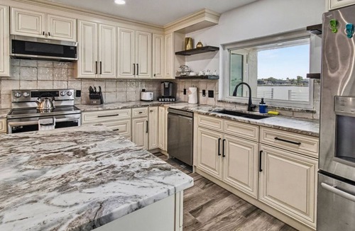 Eight Lakes Villa | Dolphin Cove Villa Gulf Access Waterfront Heated Pool & Hot Tub Game Room