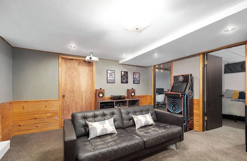 Ada House | Escape to a 4BR/2Bath wooded retreat just minutes from Grand Rapids.