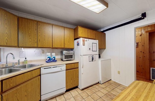Greenville Junction House | Lakefront Home with Private Dock, Pebble Beach & Enclosed Porch - Dogs Welcome