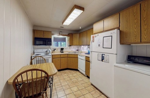 Greenville Junction House | Lakefront Home with Private Dock, Pebble Beach & Enclosed Porch - Dogs Welcome