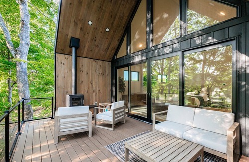 New Plymouth Cabin | Luxury Couples Cabin in Hocking Hills, Ohio with private hot tub and outdoor fireplace on covered private balcony with forest views.