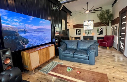 Nunica House | New renovation retro-Modern 1960s Service Station Fireplace 100″ TV garage