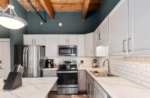 Grand Rapids Condo | Riverfront Condo for Professionals with Workspace & Prime Medical Mile Access.