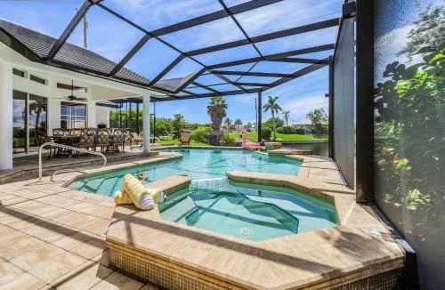 Pelican House | Riverfront Luxury with Heated Pool, Spa & Private Dock - Sunny Shores Escape