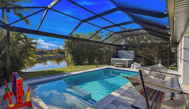 Canal front home with saltwater pool, hot tub, and washer and dryer.