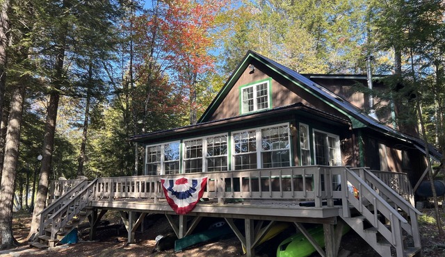 Cozy Sebec Lake front cabin with dock and fire pit