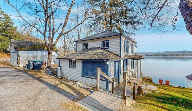 Dog-friendly cabin on the water with a sunroom, firepit, & full kitchen