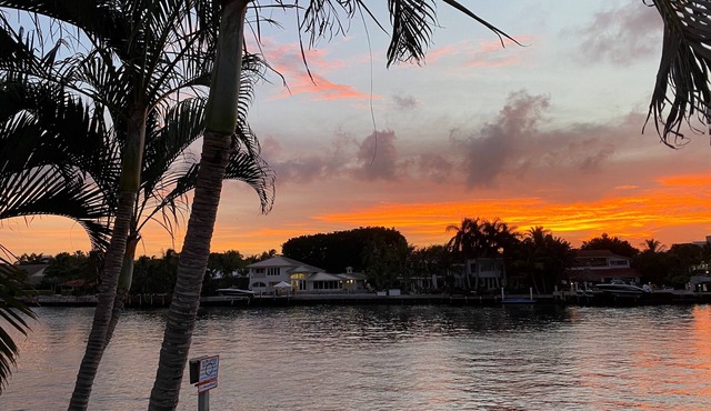 Enjoy scenic sunsets on your private deck. Modern condo minutes to the beach.