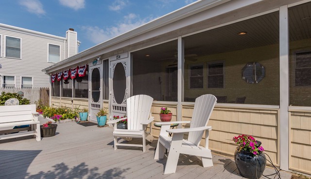 Enjoy the screened in porch just steps from the beach.